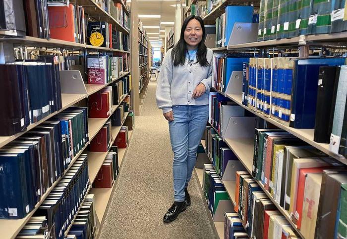 A female in the library aisle.